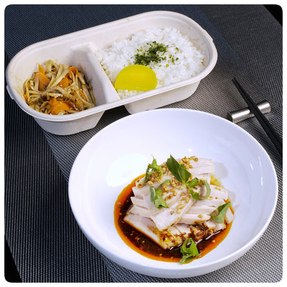 OKA-OKA Asian meal with steamed rice, pickled vegetables, and sliced chicken in spicy sauce